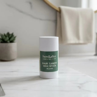 Hair tamer wax stick on a marble surface with a neutral background